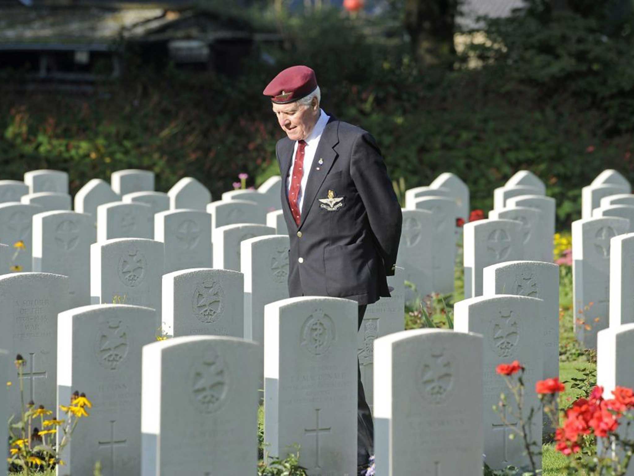 John Saint, aged 82 from East London who served in the British 1st. Battalion Parachute Regiment pay his respects to fallen comrades