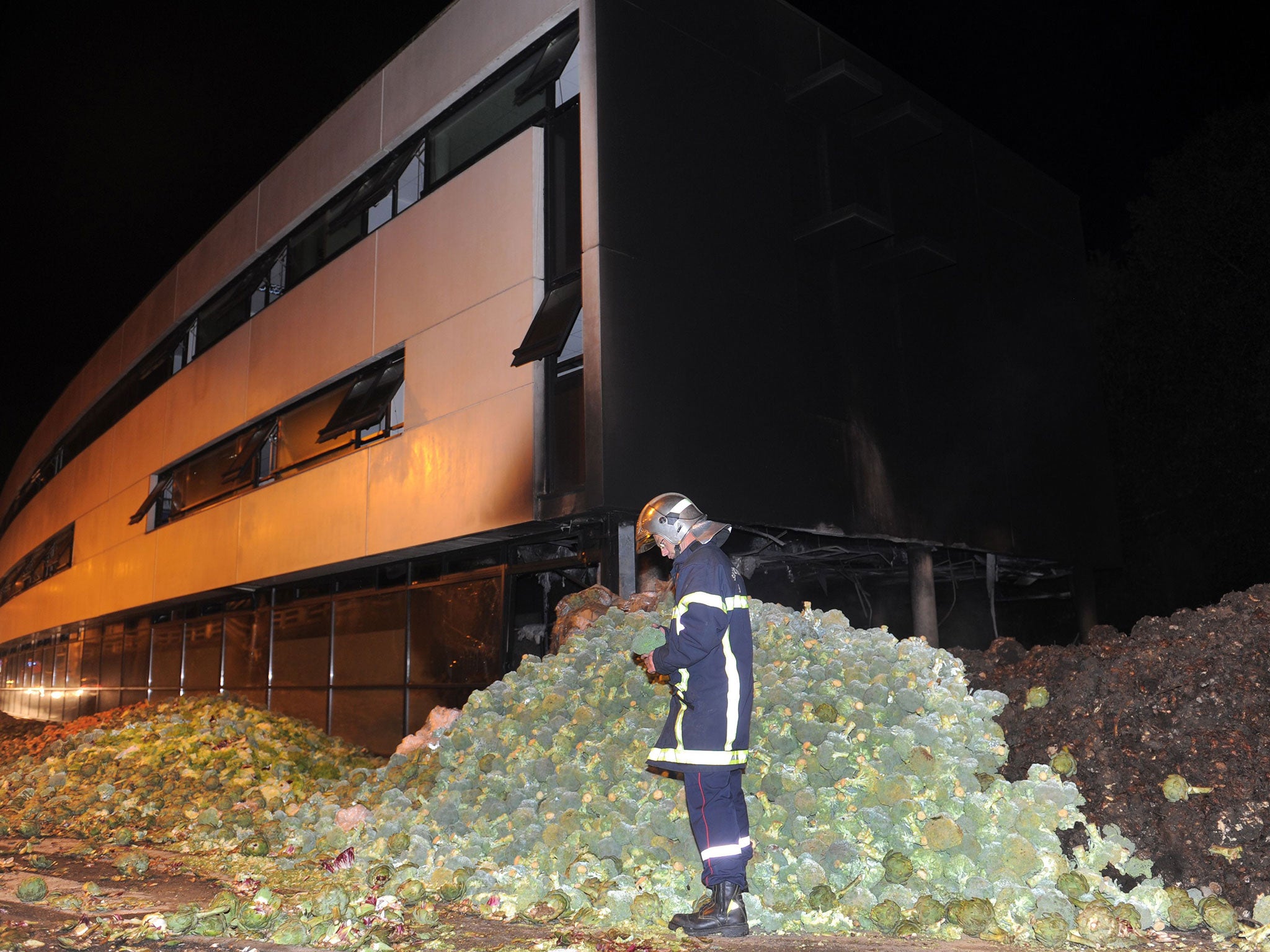 The tax center set fire by angry farmers is seen early September 20, 2014 in Morlaix, western France.