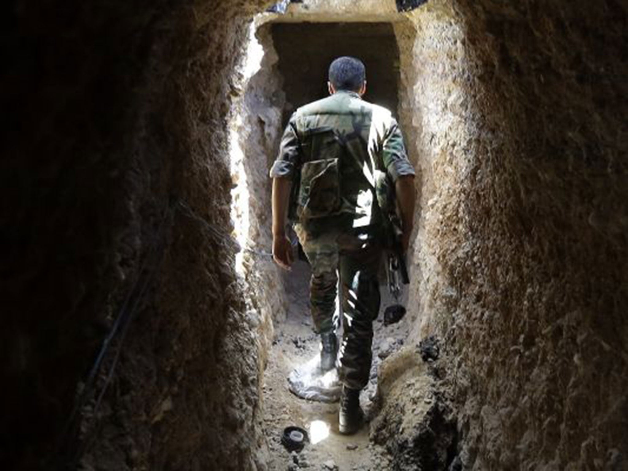Fighting chance: a Syrian army soldier in a tunnel dug by rebels