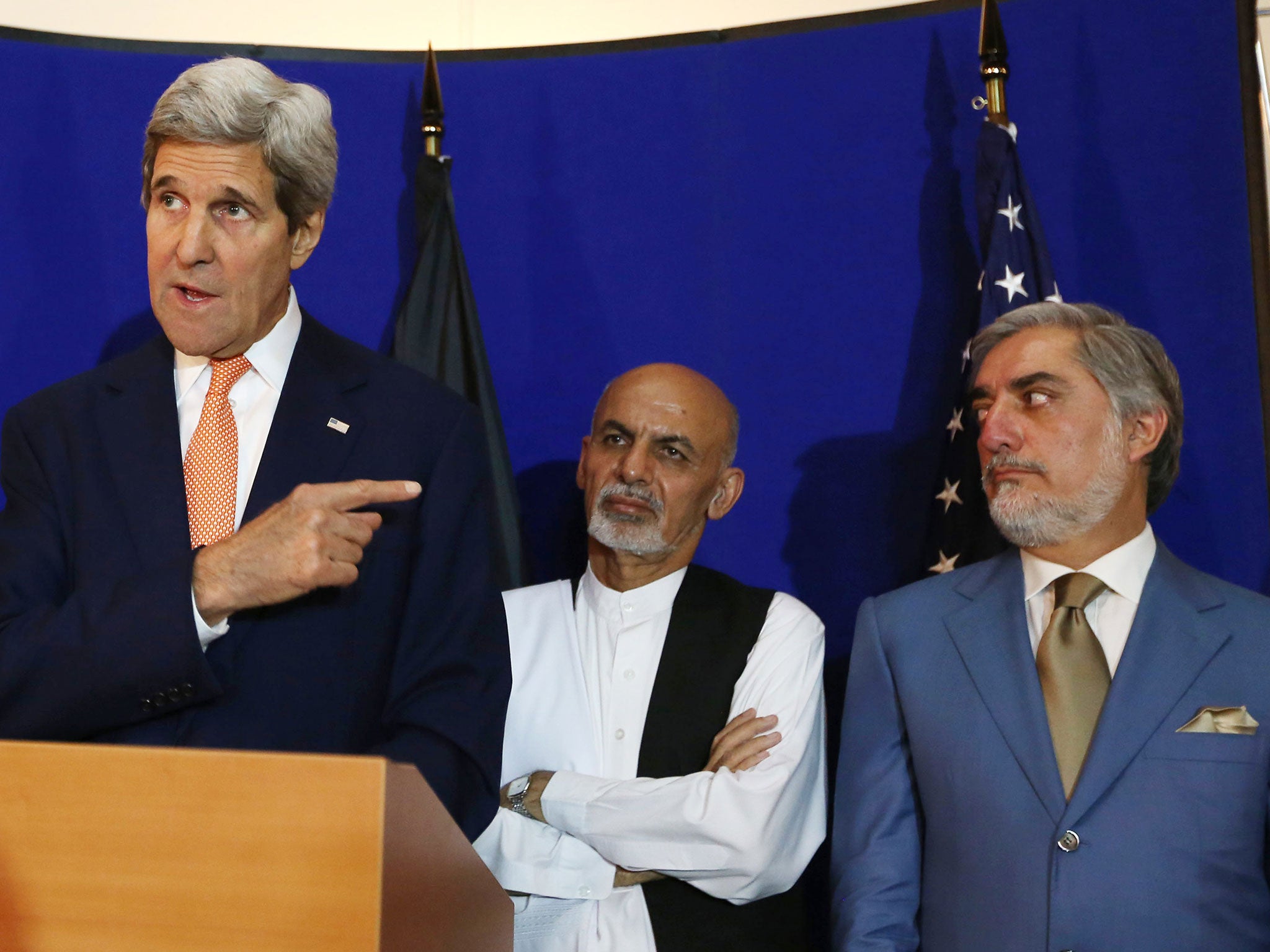 FILE - In this Friday, Aug. 8, 2014 file photo, US Secretary of State John Kerry, from left, speaks as Afghan presidential candidates Ashraf Ghani Ahmadzai and Abdullah Abdullah listen in Kabul