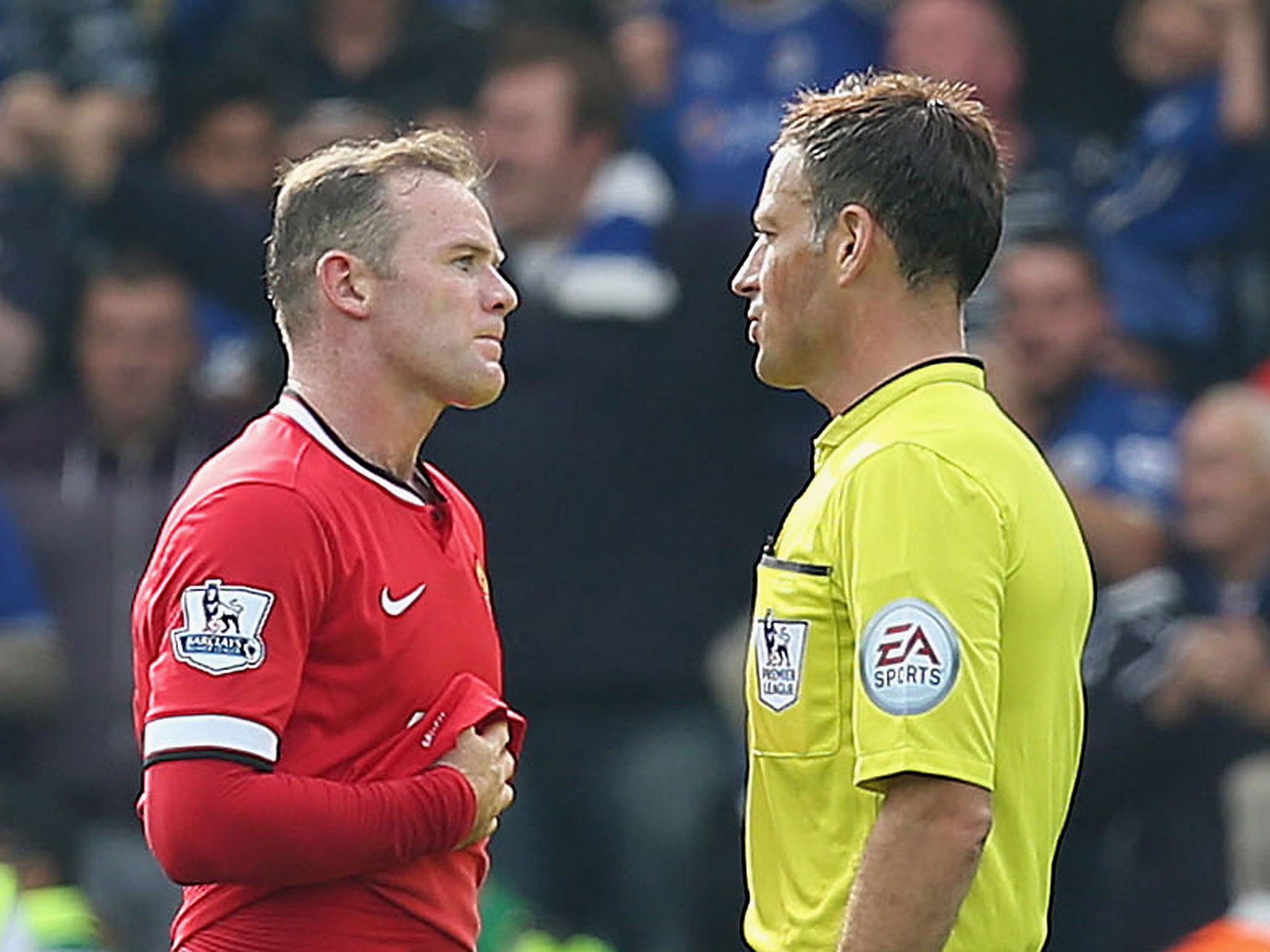 Wayne Rooney speaks with referee Mark Clattenburg