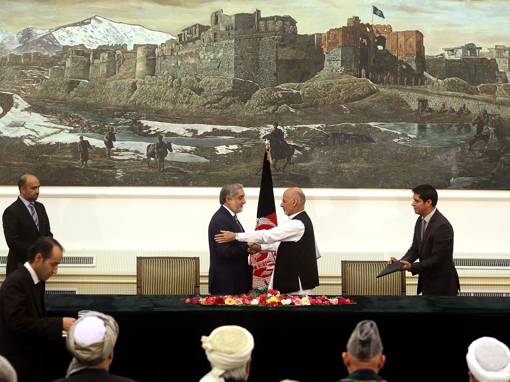 Abdullah Abdullah, left, and Ashraf Ghani Ahmadzai, shake hands after signing a powersharing deal in Kabul