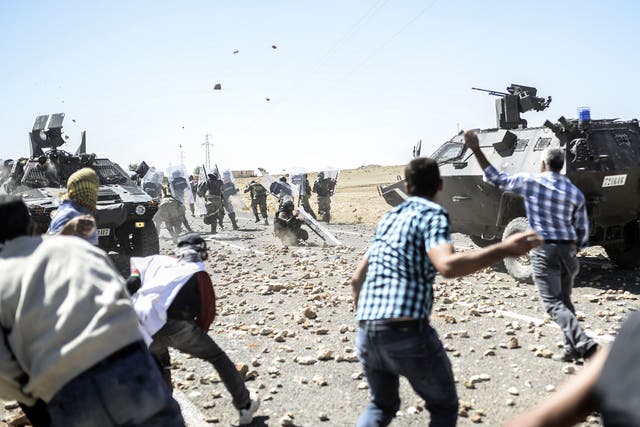 Kurdish refugees clash with Turkish soldiers near the Syrian border after Ankara temporarily closed the Suruc crossing
