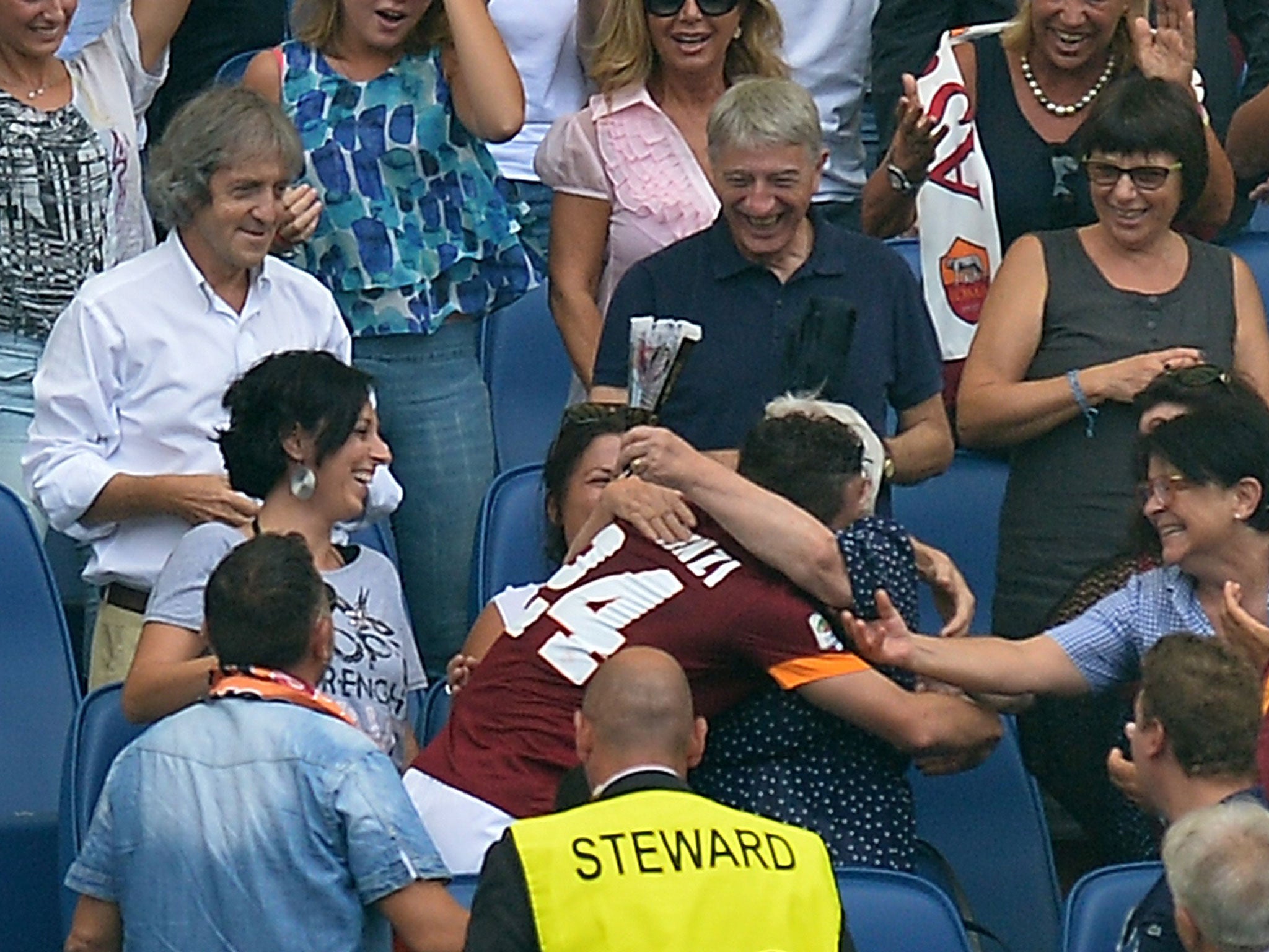 Alessandro Florenzi hugs his grandmother in the stands before picking up the booking