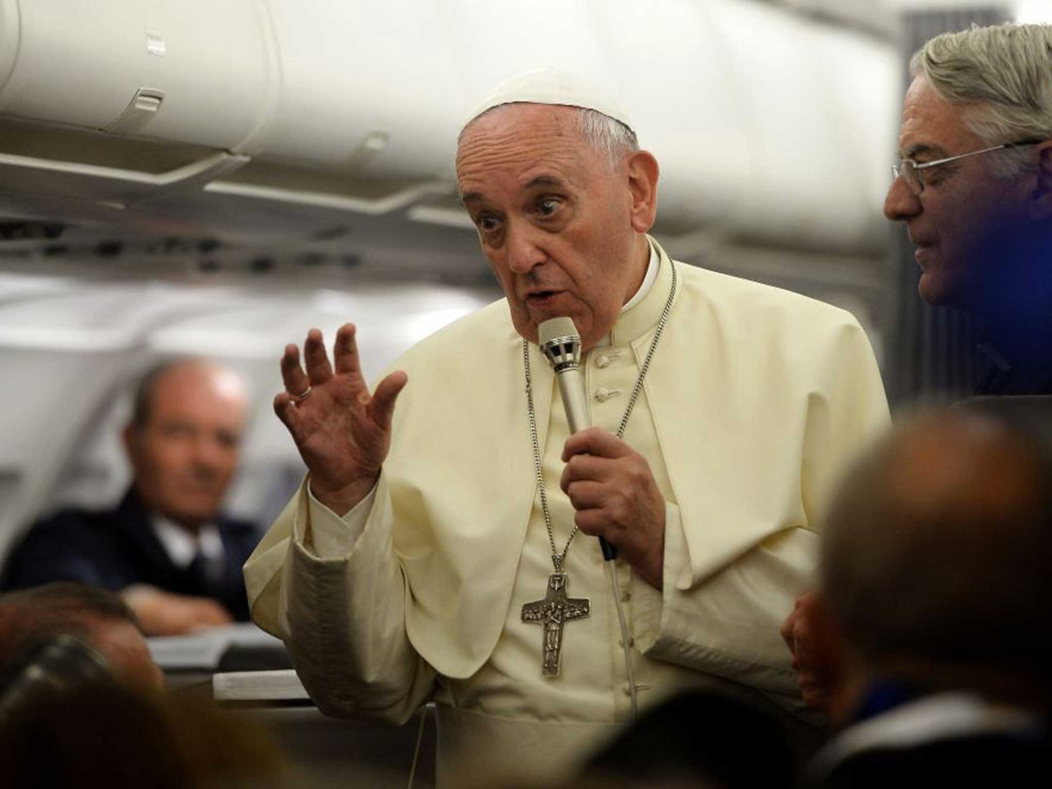Pope Francis talks to reporters yesterday