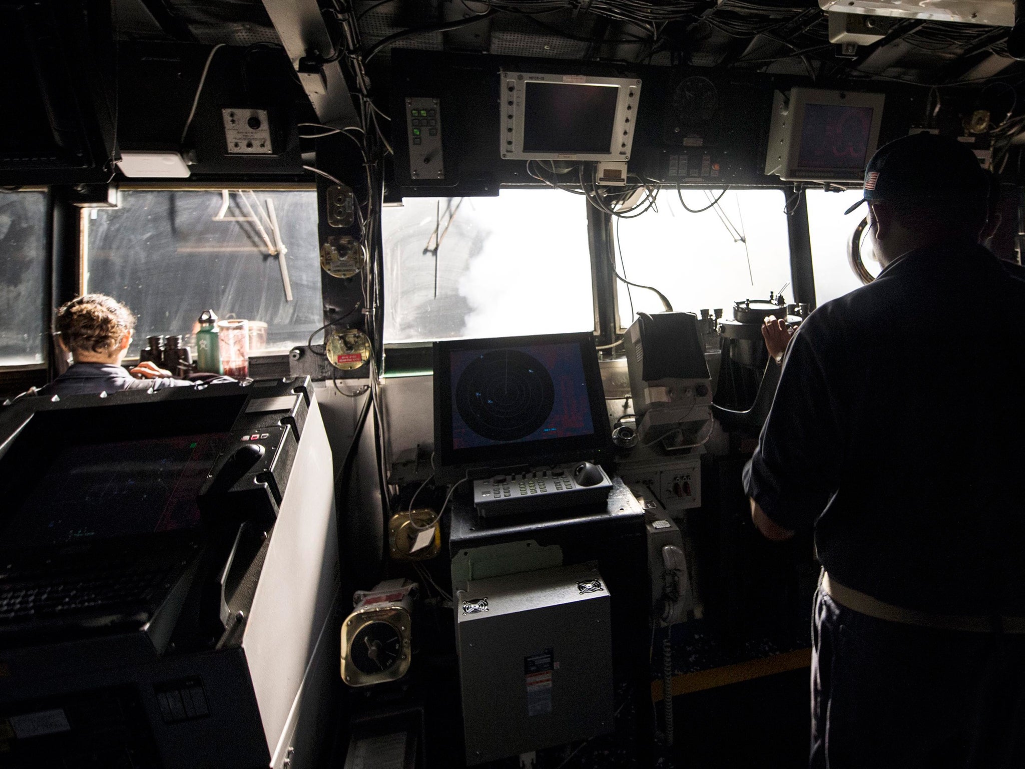 US navy sailors standing watch on the bridge while Tomahawk cruise missiles are launched against Isis targets in Syria, aboard the guided-missile cruiser USS Philippine Sea (CG 58), in the Arabian Gulf