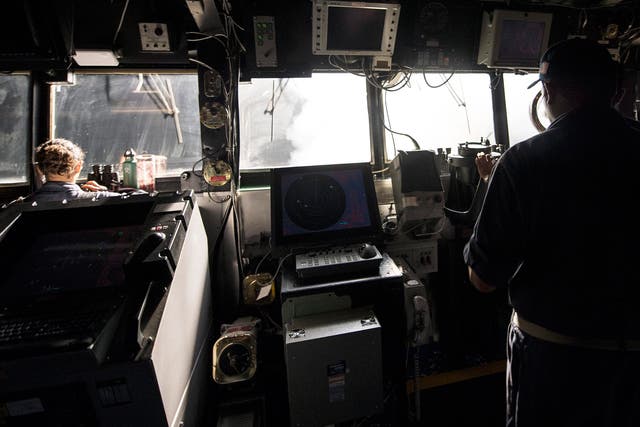 US navy sailors standing watch on the bridge while Tomahawk cruise missiles are launched against Isis targets in Syria, aboard the guided-missile cruiser USS Philippine Sea (CG 58), in the Arabian Gulf