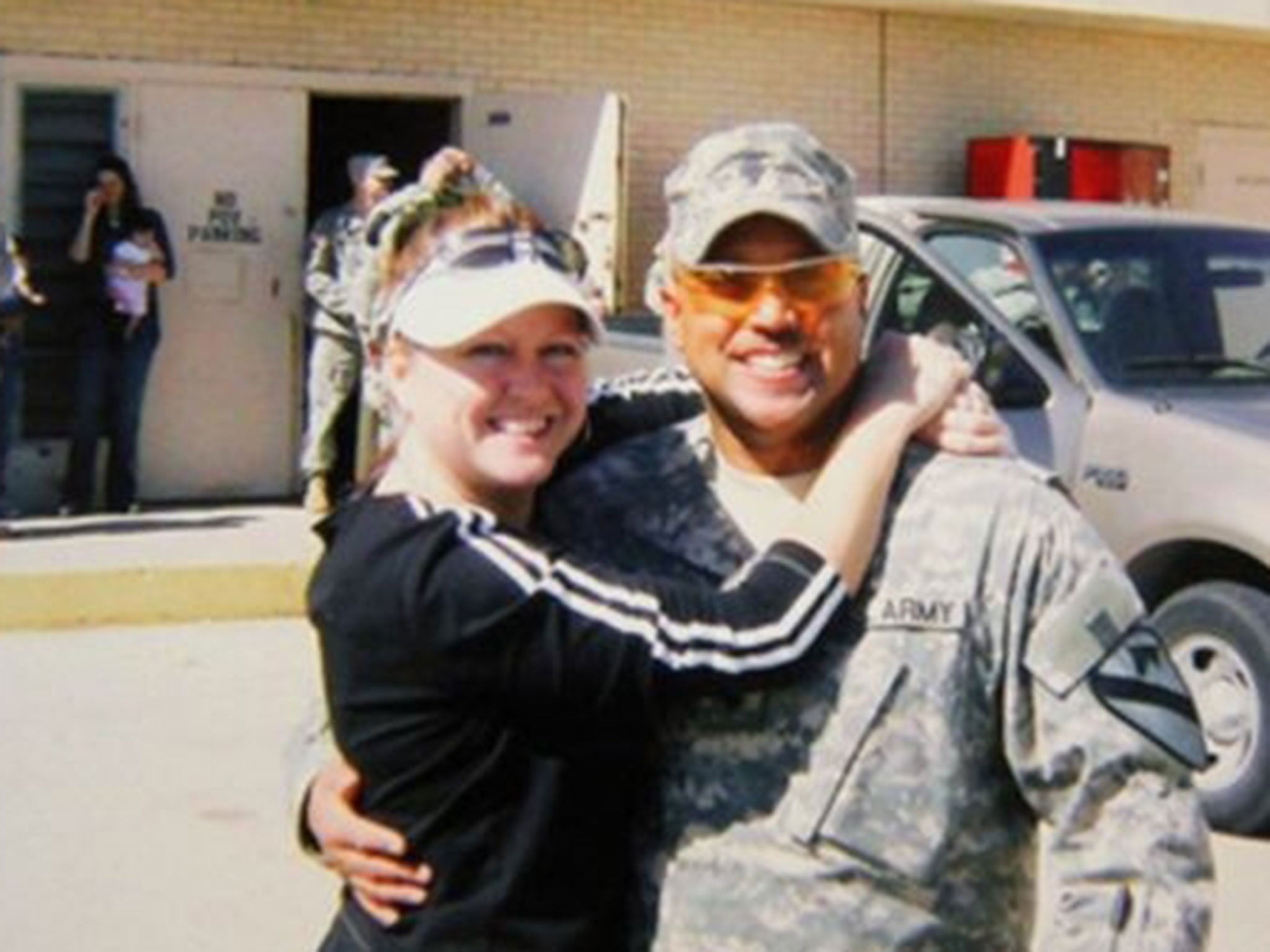 Omar Gonzalez poses for a photo in his Army uniform with his former wife Samantha, prior to an overseas deployment.