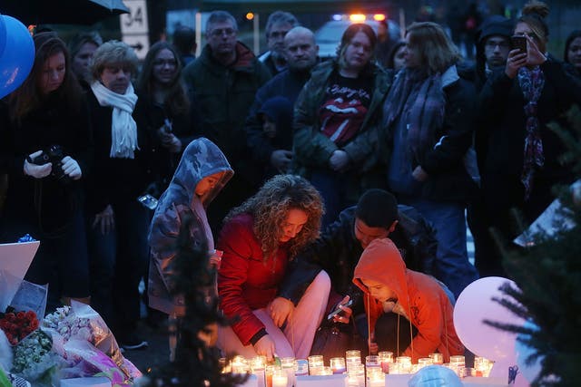 People gather at a memorial for victims following the mass shooting at Sandy Hook Elementary School in Newtown in December 2012