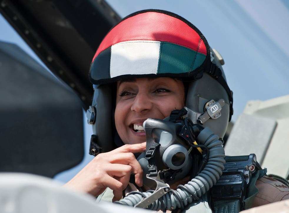 Major Mariam al-Mansouri, the first female pilote to join the Emirates Air Forces, gesturing as she sits in the cockpit of her F-16 fighter jet.