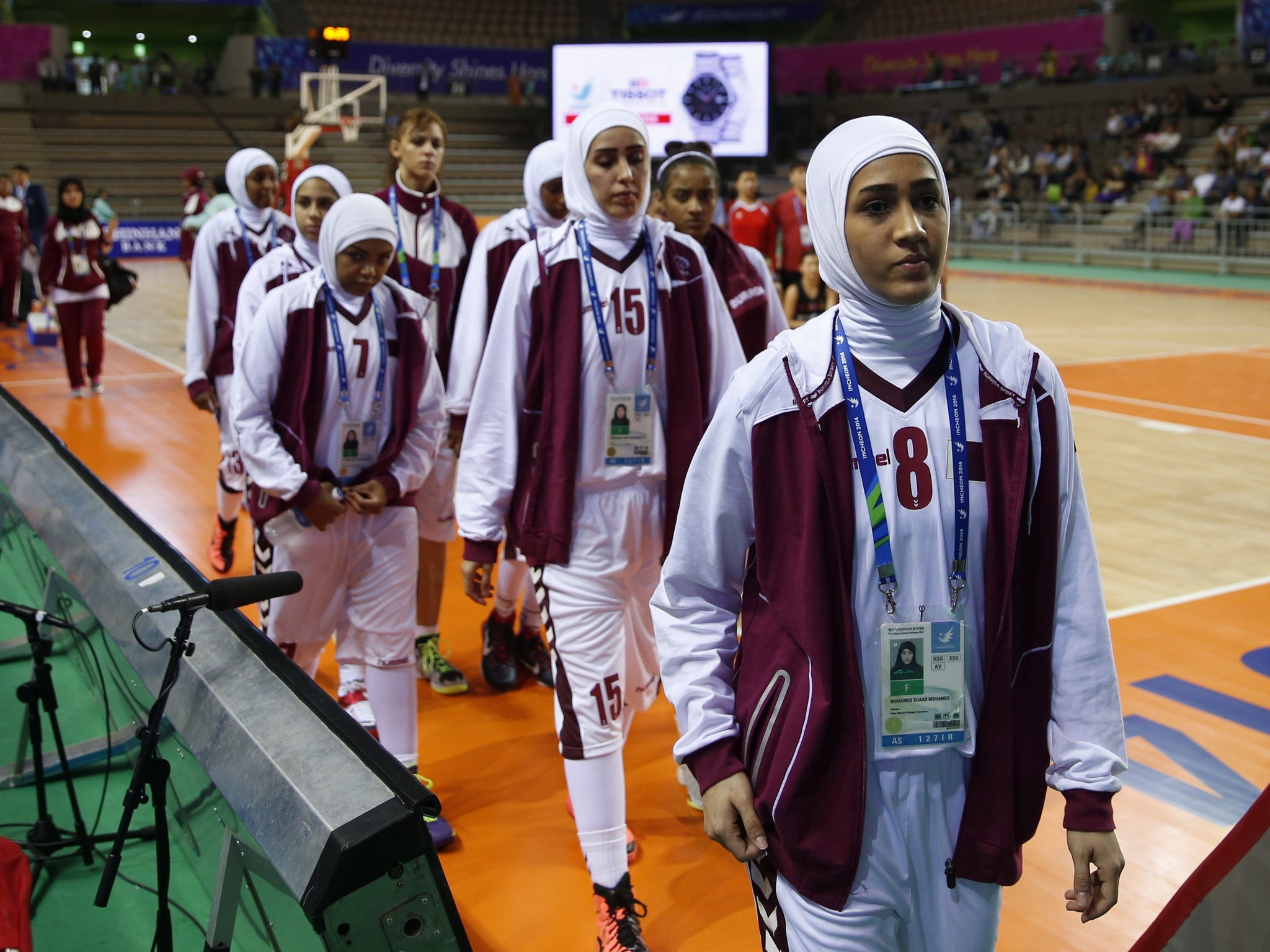 This photo taken on September 24, 2014 shows members of the Qatar women's basketball team walking off the court after withdrawing ahead of their women's preliminary round match against Mongolia during the 17th Asian Games at the Hwaseong Sports Complex Gy