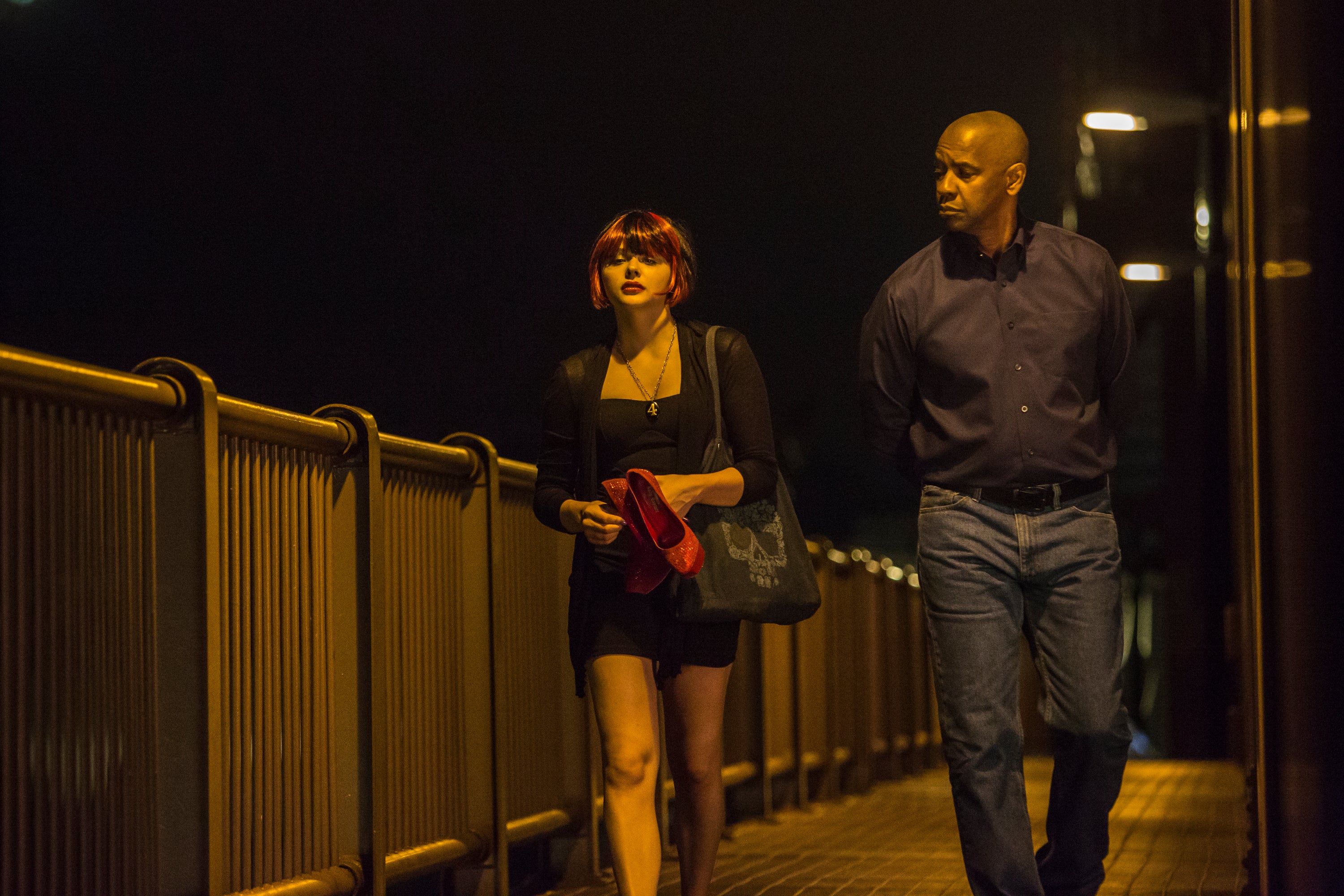 Teri (Chloe Grace Moretz) and McCall (Denzel Washington) walk across the bridge in Boston in Columbia Pictures' The Equalizer
