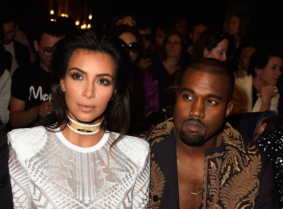 Kim Kardashian West and Kanye West on the front row of the Balmain fashion show in Paris, September 2014