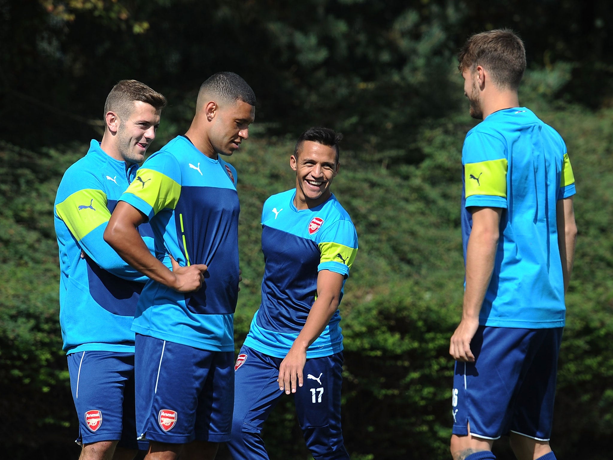 Arsenal players share a joke during training