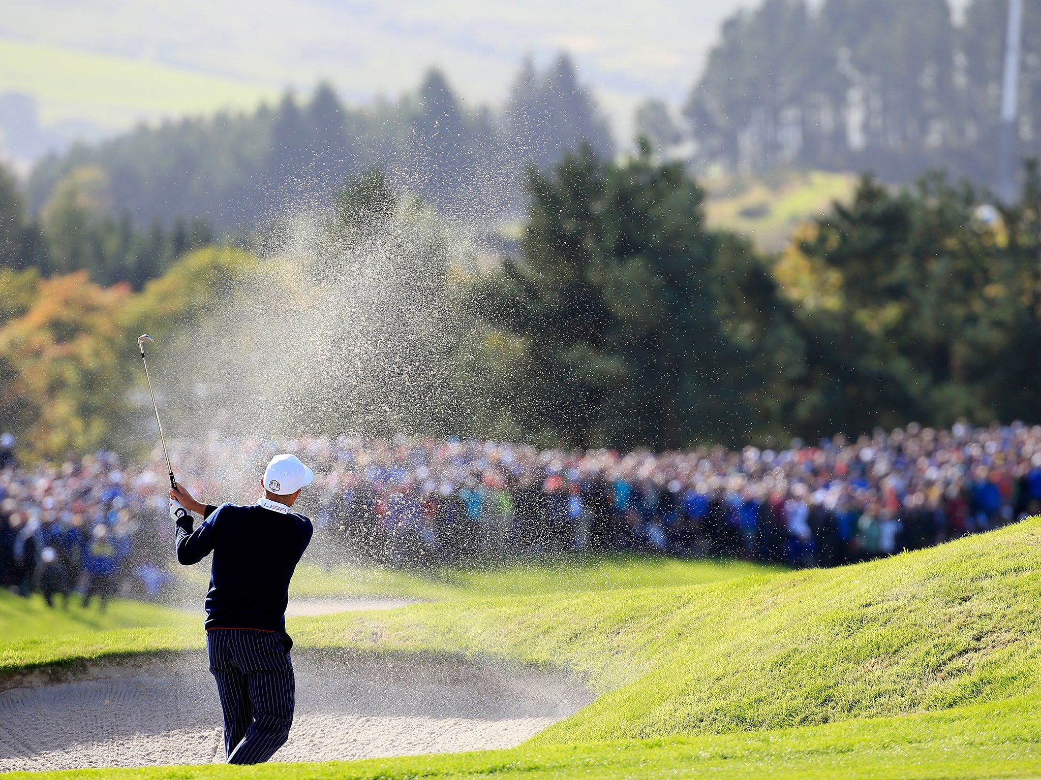 Rickie Fowler of the United States chips from the bunker on the 16th hole during the Morning Fourballs of the 2014 Ryder Cup on the PGA Centenary course at the Gleneagles Hotel in Auchterarder, Scotland