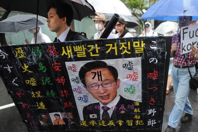 Zaitokukai members wave racist placards during an
anti-Korean rally in Tokyo