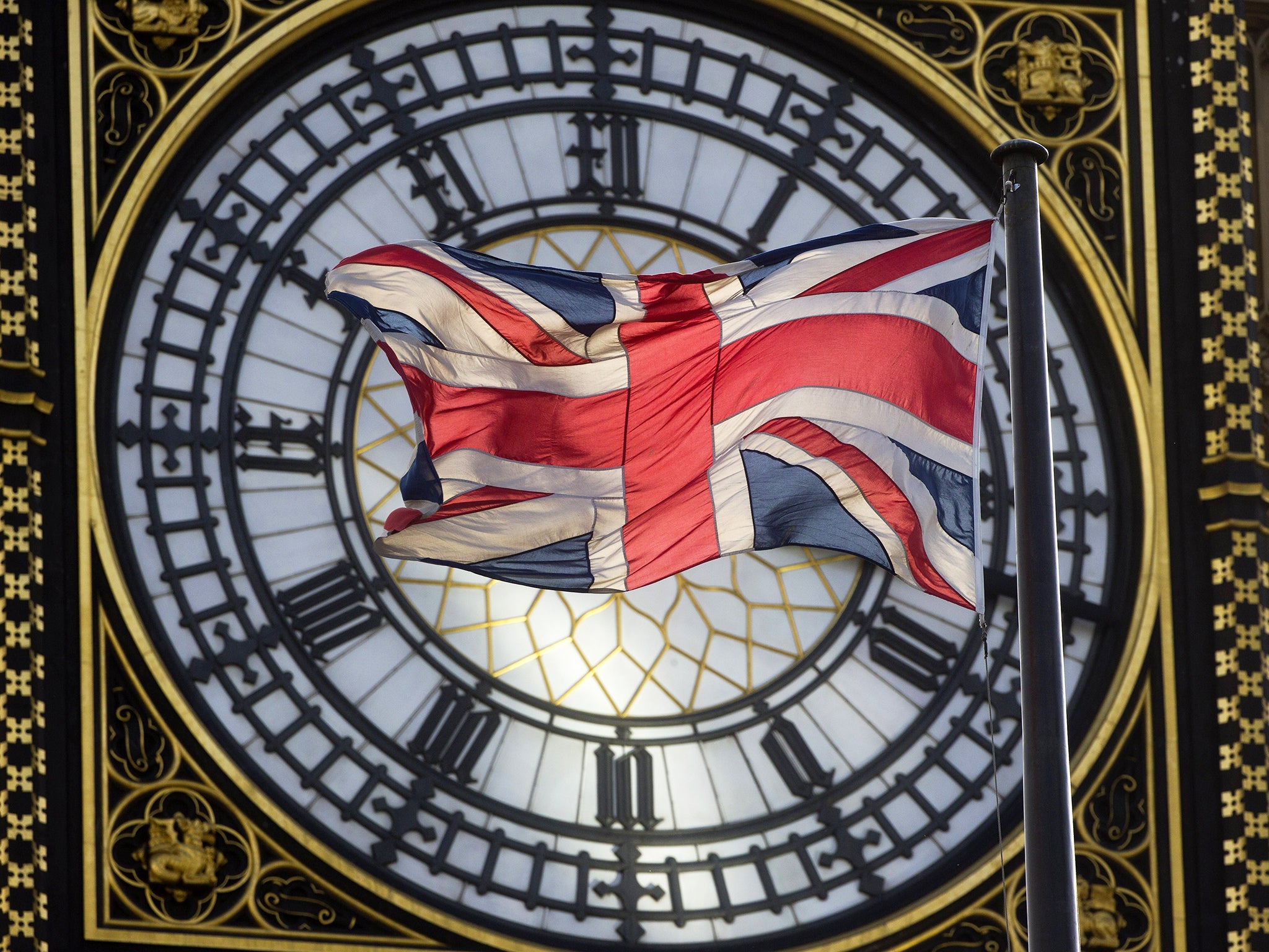 The Union flag is seen flapping in the wind in front of one of the faces of the Great Clock atop the landmark Elizabeth Tower that houses Big Ben at the Houses of Parliament