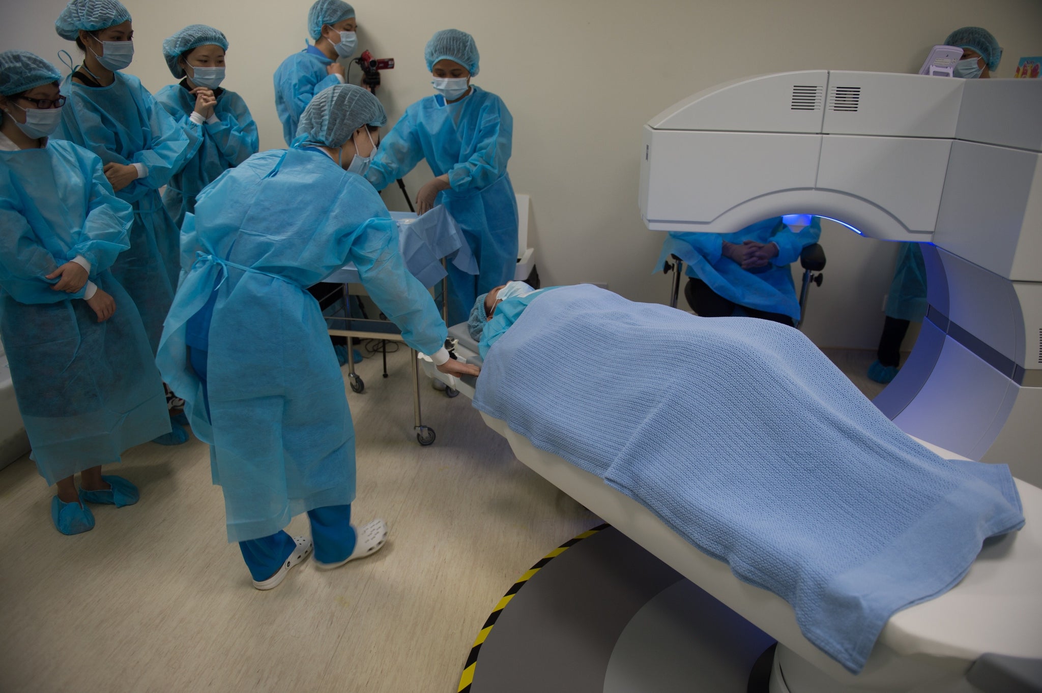 Staff prepare to treat a patient with laser surgery.