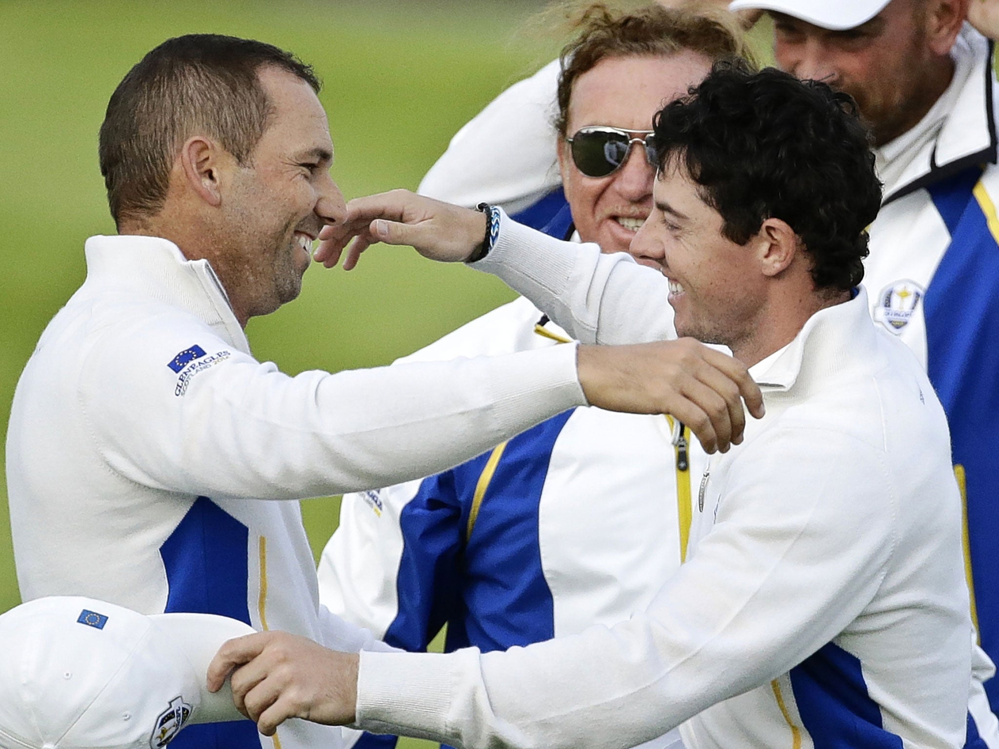 Sergio Garcia and Rory McIlroy embrace after beating Jim Furyk and Hunter Mahan