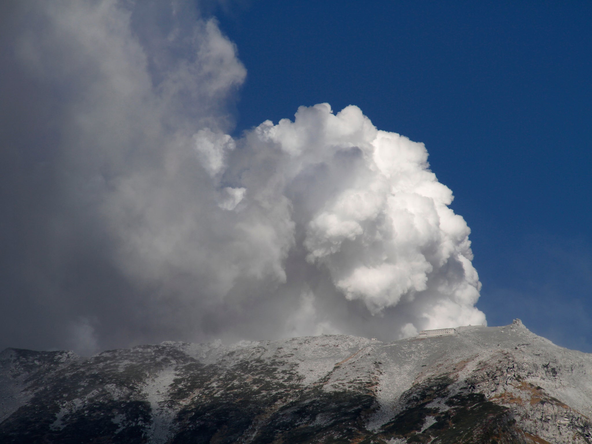Plumes of smoke and ash billow from Mount Ontake as it continues to erupt in Otaki village, in Nagano prefecture, Japan