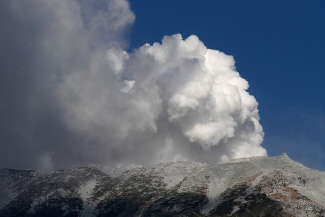 Plumes of smoke and ash billow from Mount Ontake as it continues to erupt in Otaki village, in Nagano prefecture, Japan