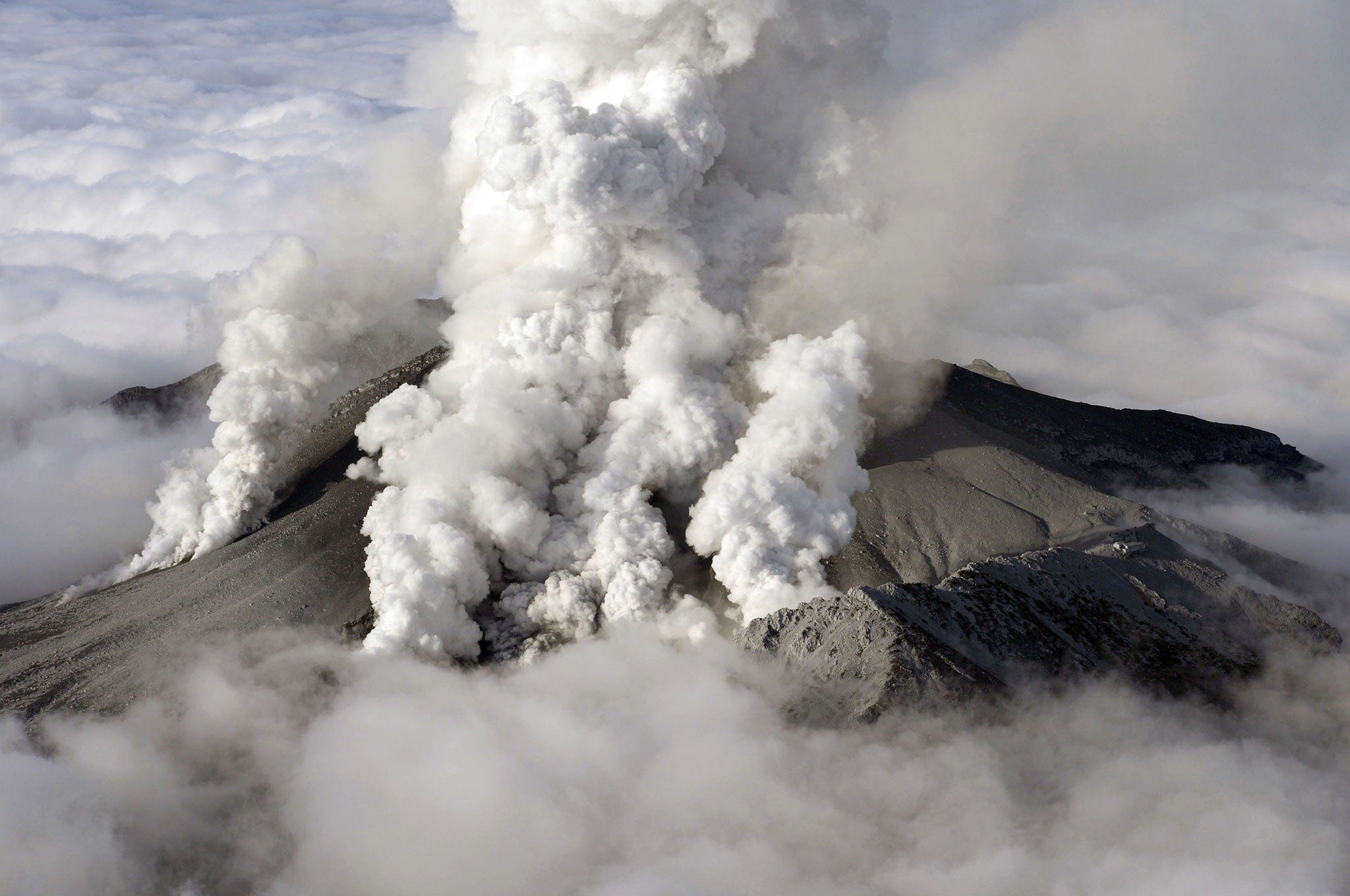 This aerial picture shows white smokes rising from Mount Ontake at Nagano prefecture, one day after Japan's volcano Ontake erupted in central Japan