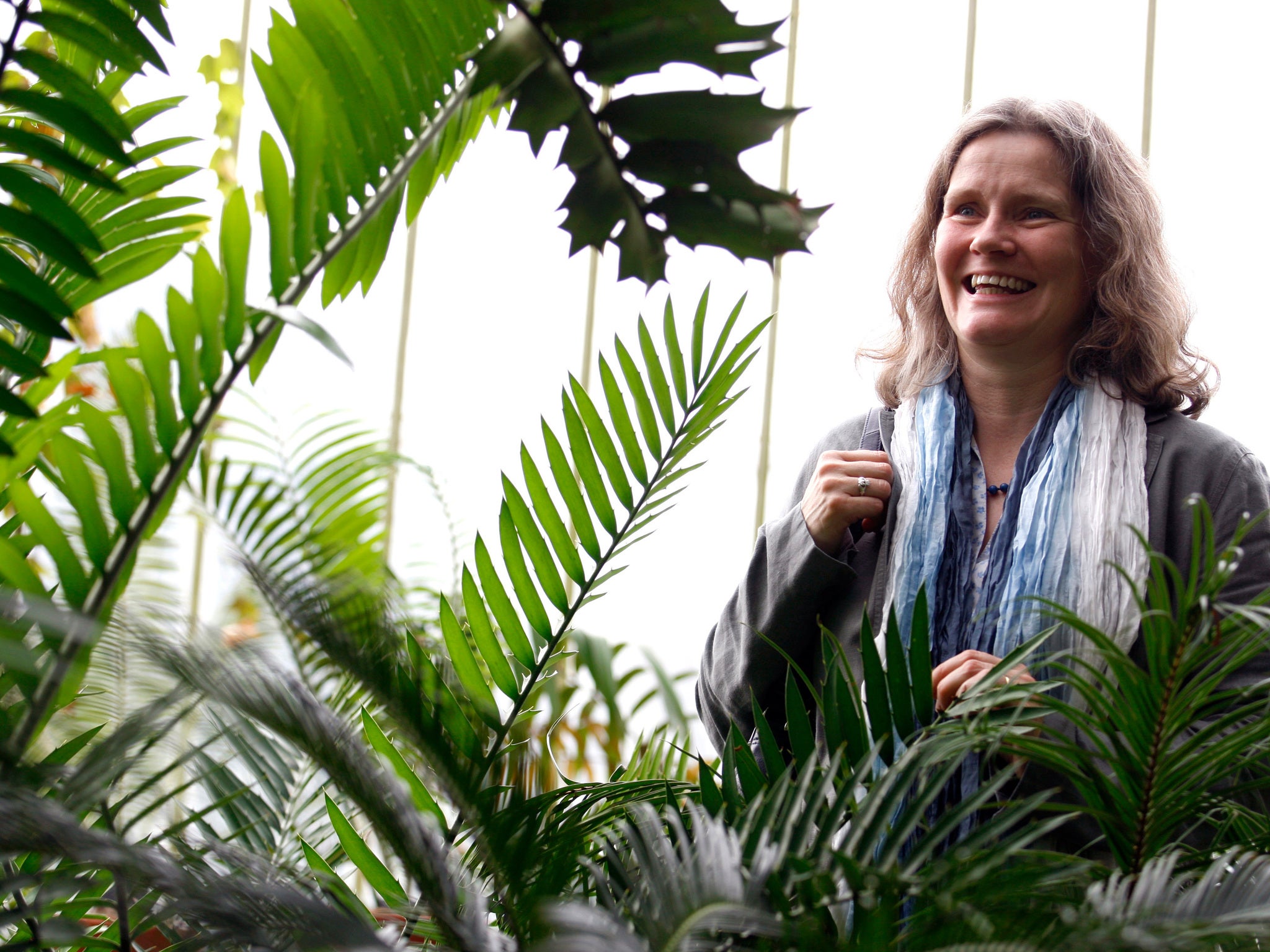 Senior scientist Eimear Nic Lughadha poses for a photograph in a greenhouse in Kew Gardens