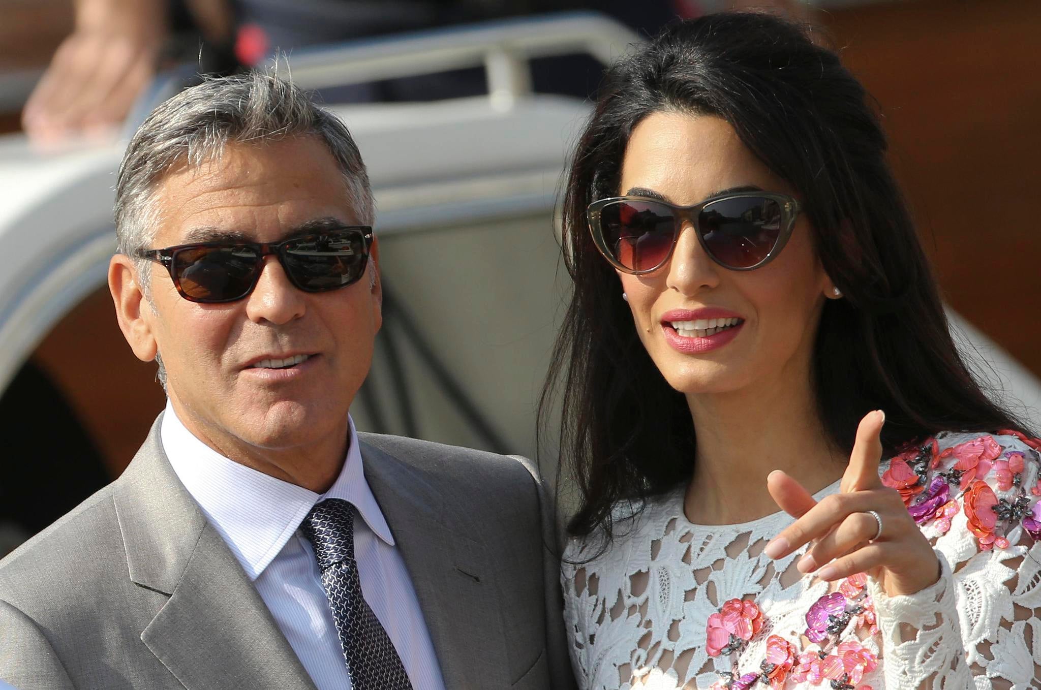 George Clooney and his Lebanon-born British wife Amal Alamuddin take a water taxi after tying the knot at a ceremony yesterday