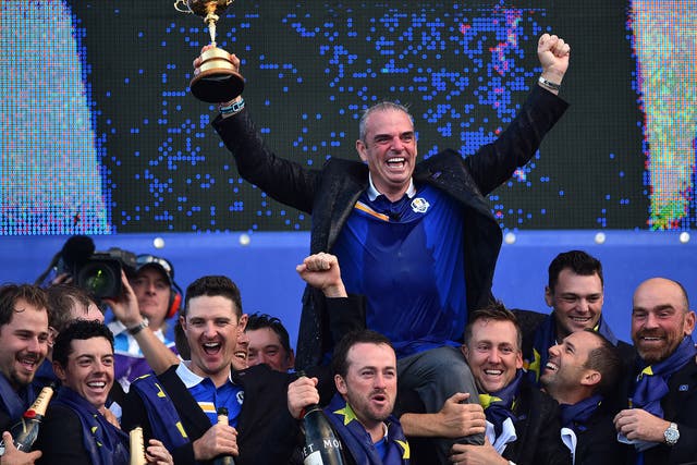 Captain of Team Europe Paul McGinley of Ireland holds the trophy after Team Europe retained the Ryder Cup