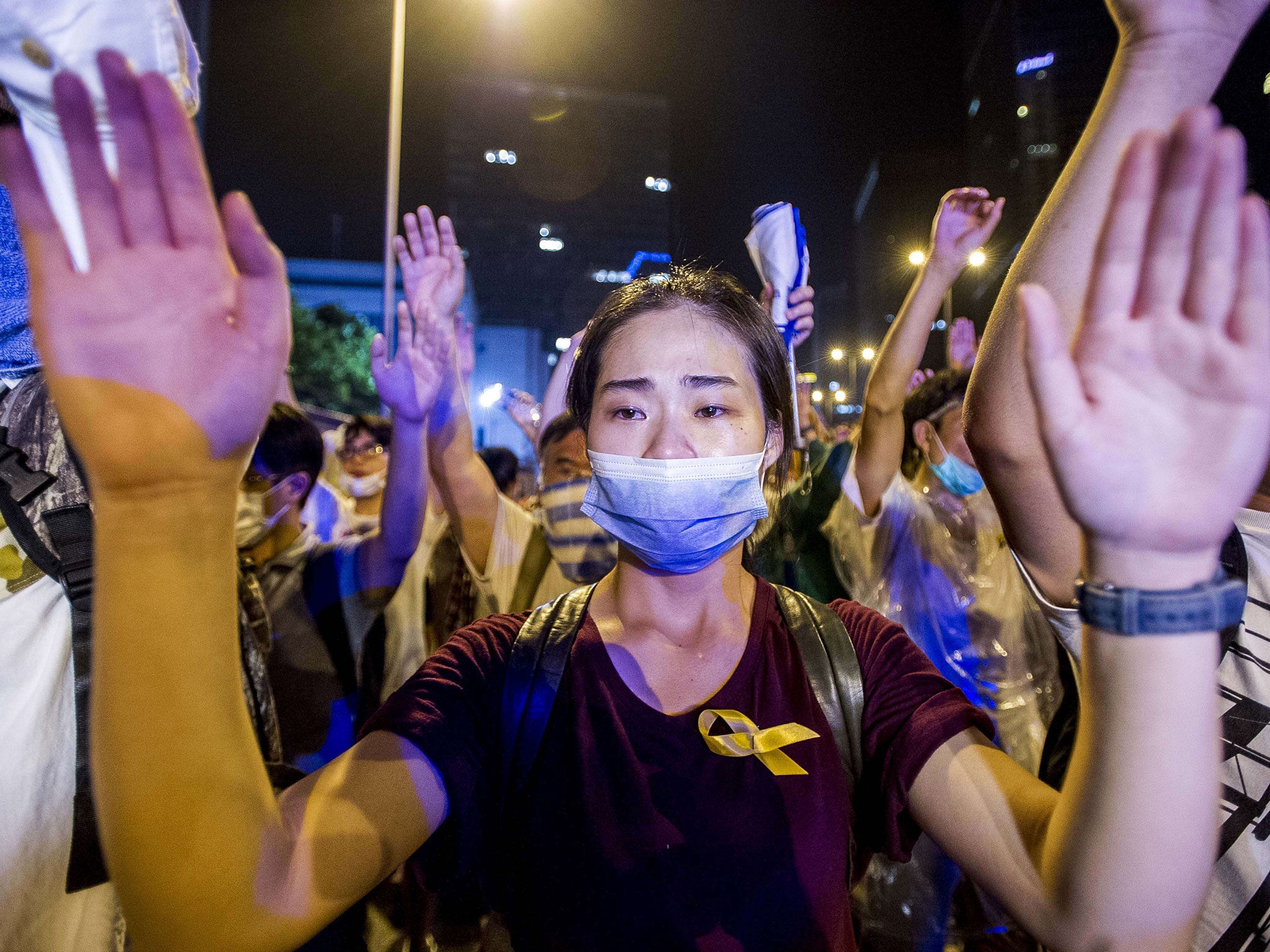 A demonstrator gestures opposite policemen during a pro-democracy protest in Hong Kong