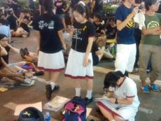 Students do their homework in the streets