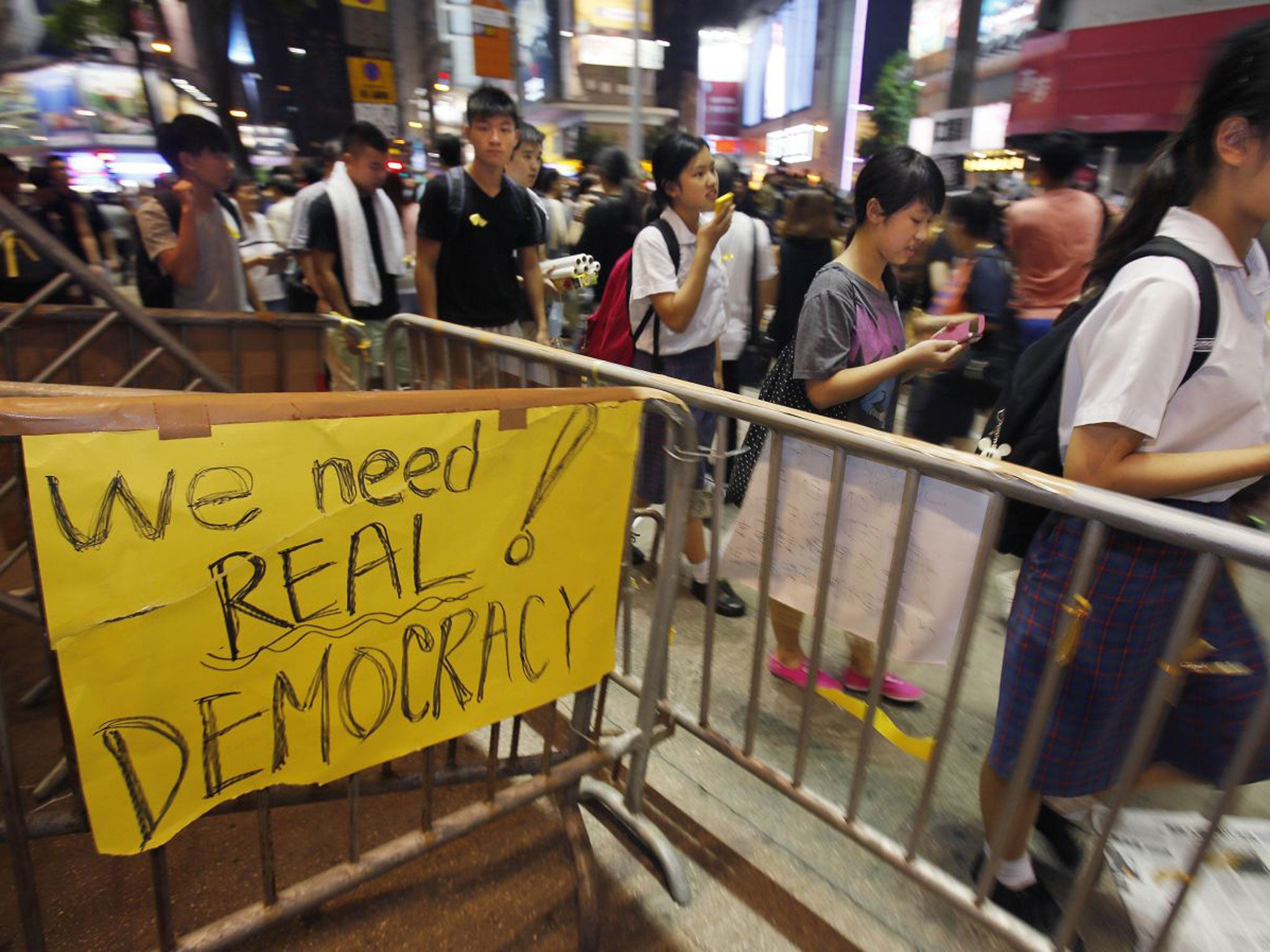 Students gather to attend a sit-in to block main roads of a popular fashion district in Hong Kong