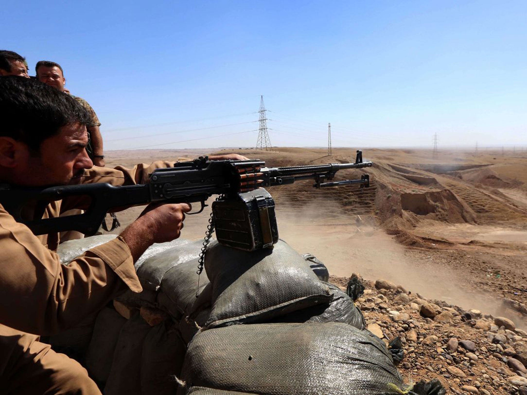 Peshmerga fighters hold a position behind sandbags in Diyala province, which is a gateway to Baghdad, as battles with Isis fighters continue