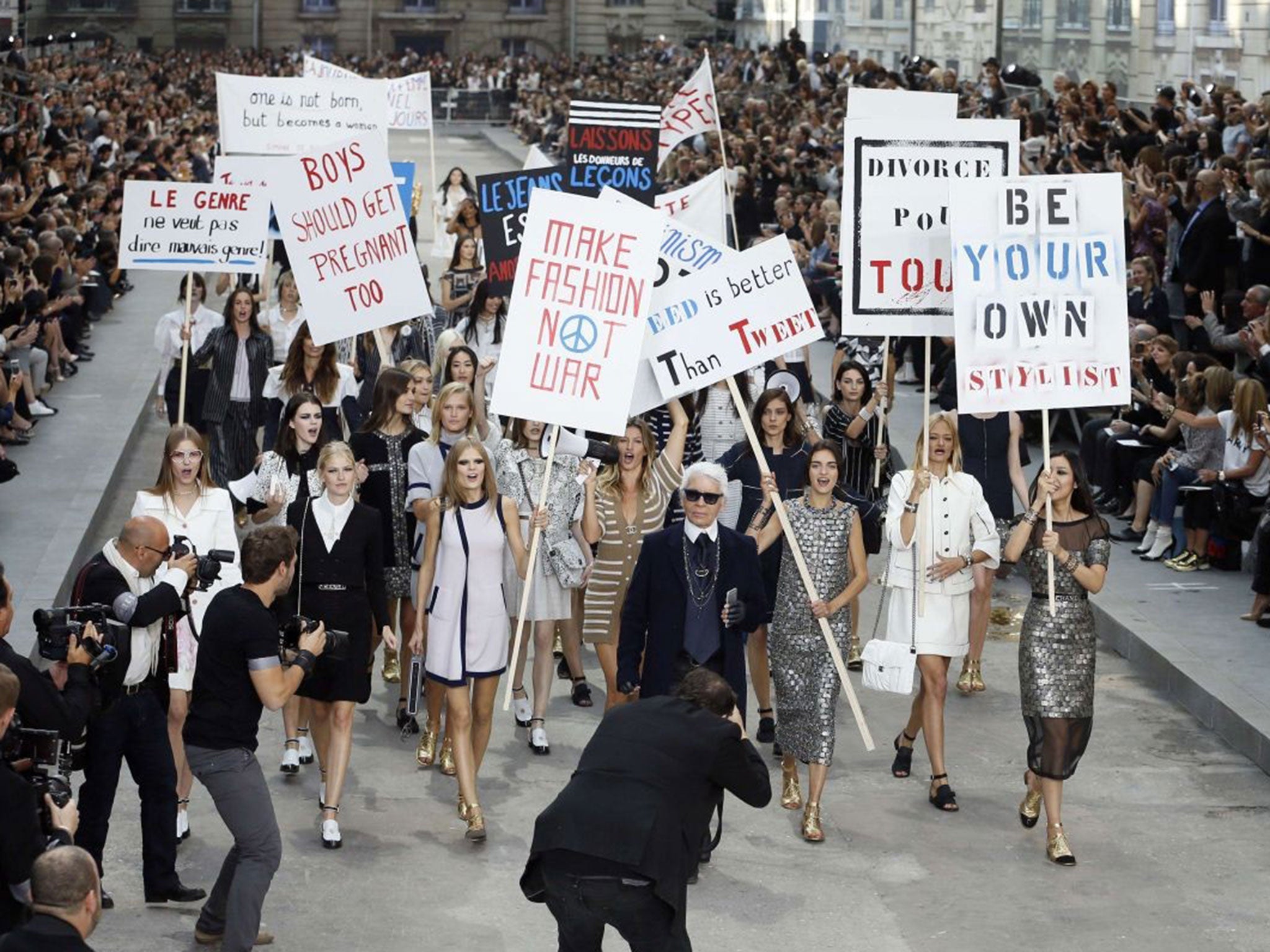 Karl Lagerfeld and Brazilian model Gisele Bundchen lead the models the fashion riot at the finale of Chanel's show