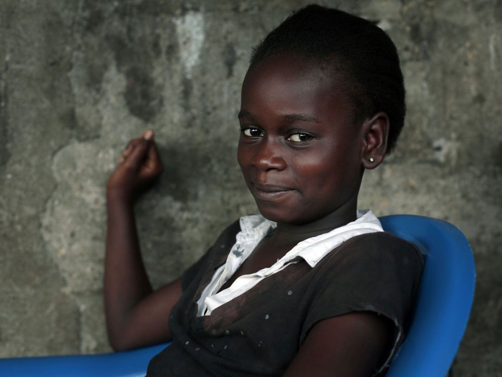 Kumba Fayah, 11, lost both parents and her sister to the Ebola virus and is now living with her extended family.