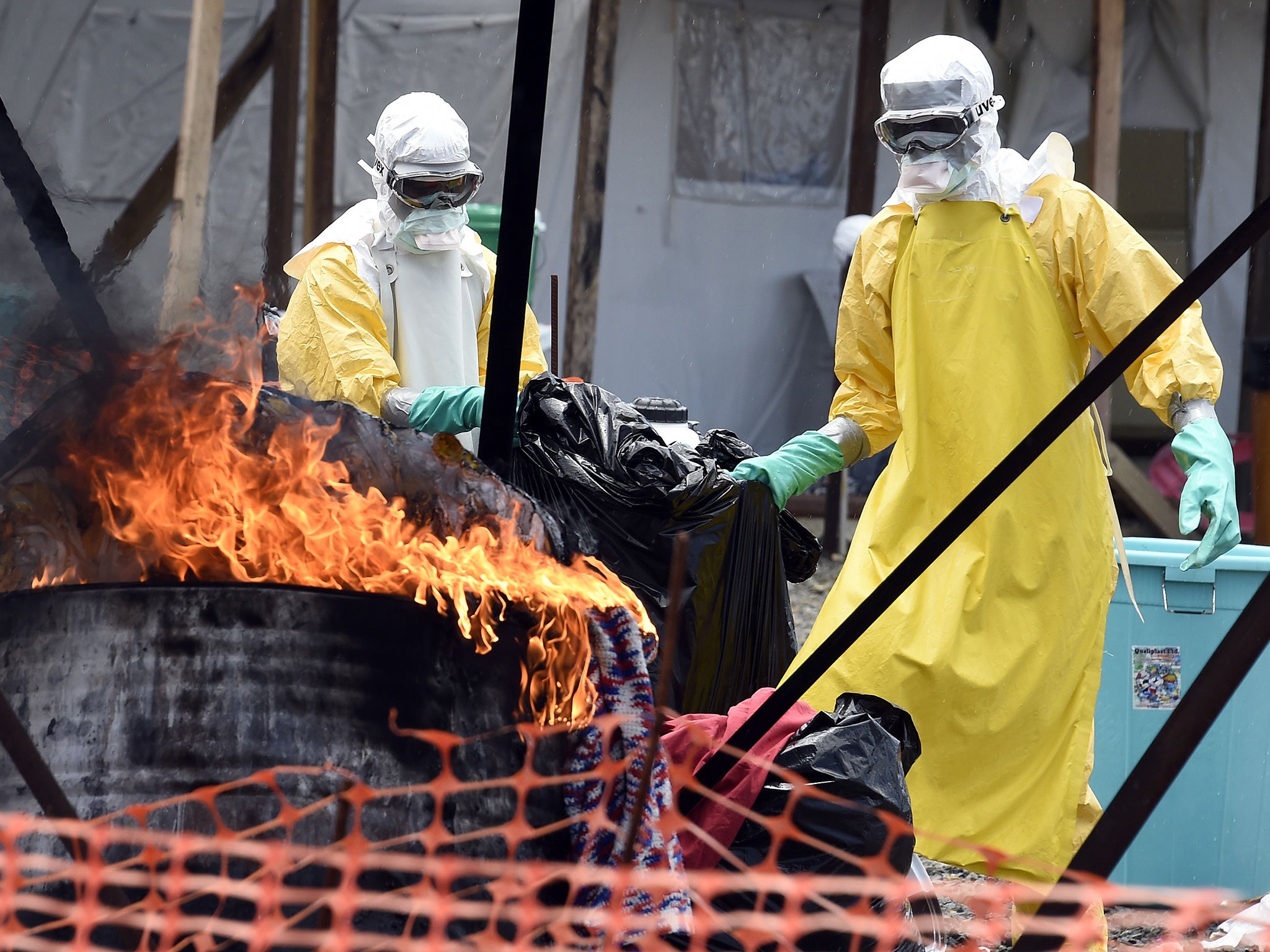 Medical staff members burn clothes belonging to patients suffering from Ebola, at the French medical NGO Medecins Sans Frontieres (MSF) in Monrovia