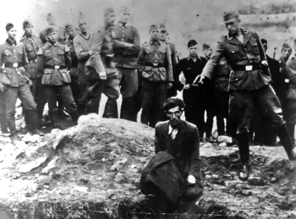 An Einsatzgruppe D soldier about to shoot a Jew kneeling at a partially filled mass grave in Vinnitsa, Soviet Union, in 1942