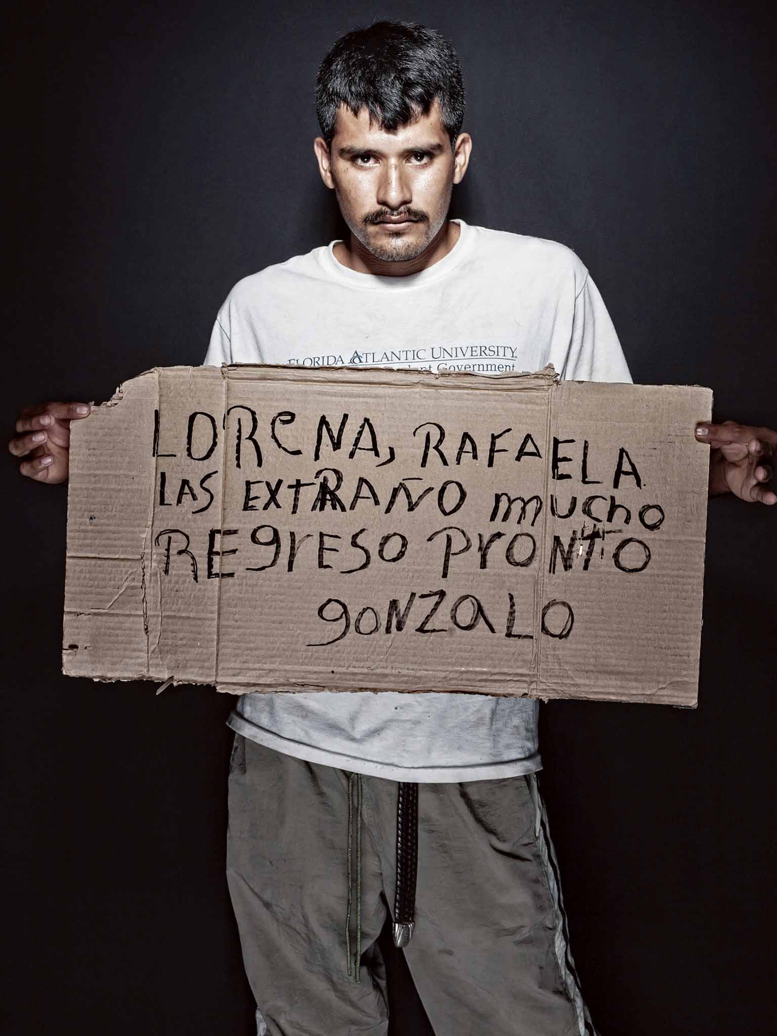 Gonzalo: As an undocumented Honduran in Mexico, the 22-year-old still hoped to make it to the US, and held up this message for his wife and nine-month-old daughter in Honduras: 'Lorena, Rafaela, I miss you a lot. Back soon' (Nicola Ókin Frioli/www.nicolao