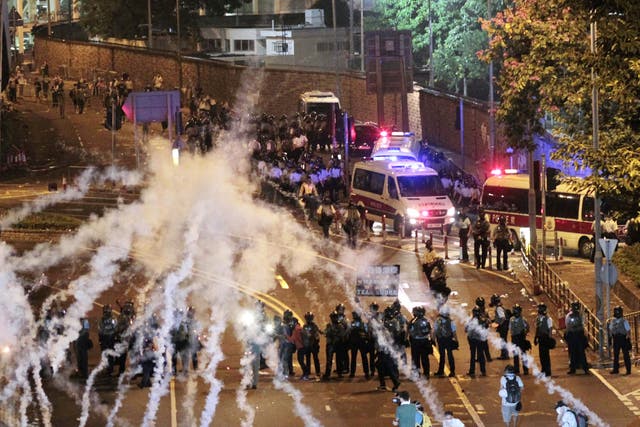 Riot police fire tear gas on student protesters occupying streets surrounding the government headquarters in Hong Kong