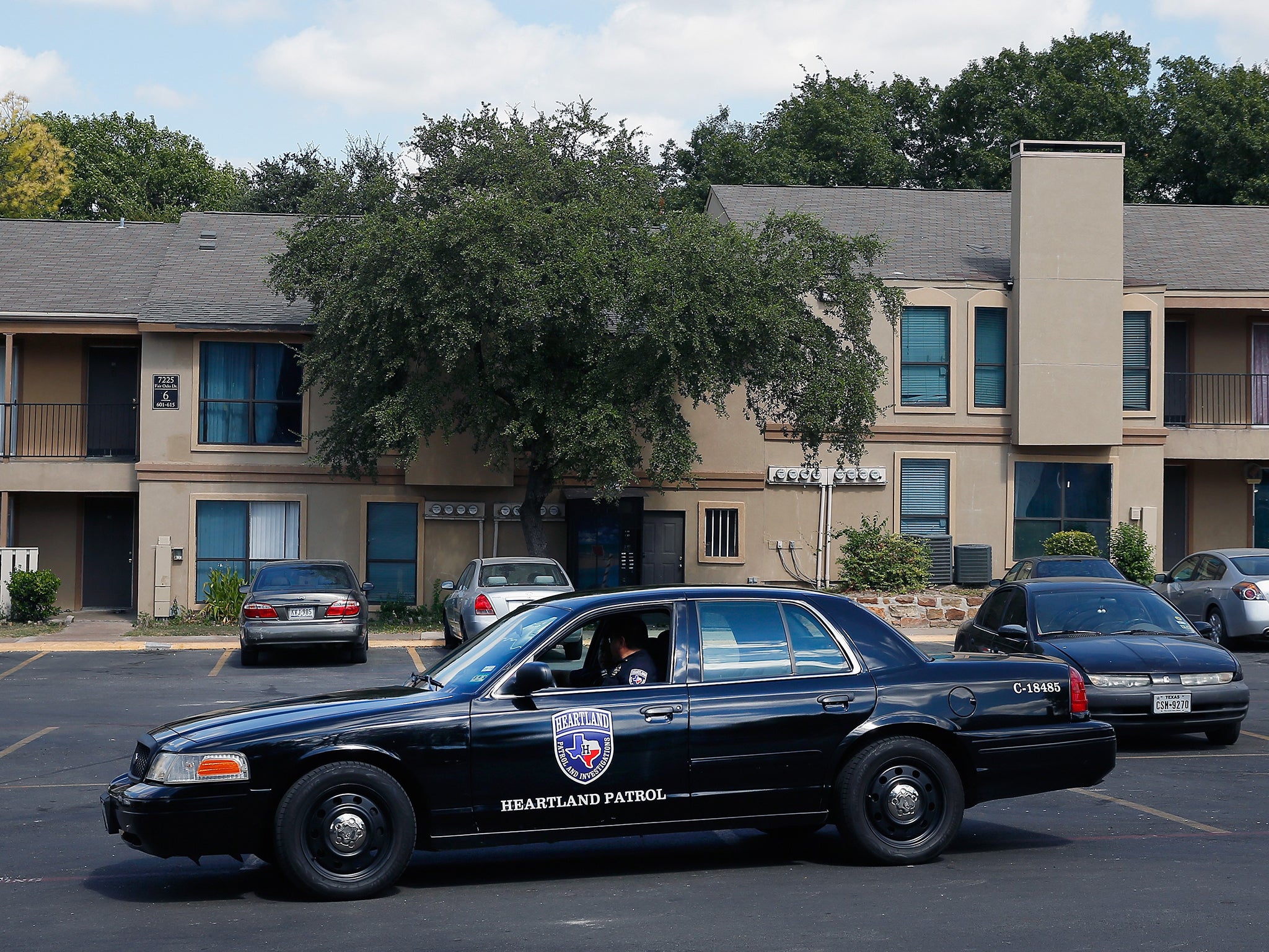 A security guard patrols The Ivy Apartments, where the Ebola patient was staying