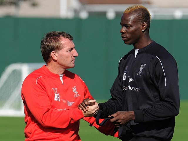 Brendan Rodgers and Mario Balotelli at Liverpool’s
training ground yesterday