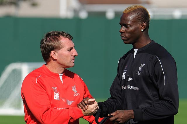 Brendan Rodgers and Mario Balotelli at Liverpool’s
training ground yesterday