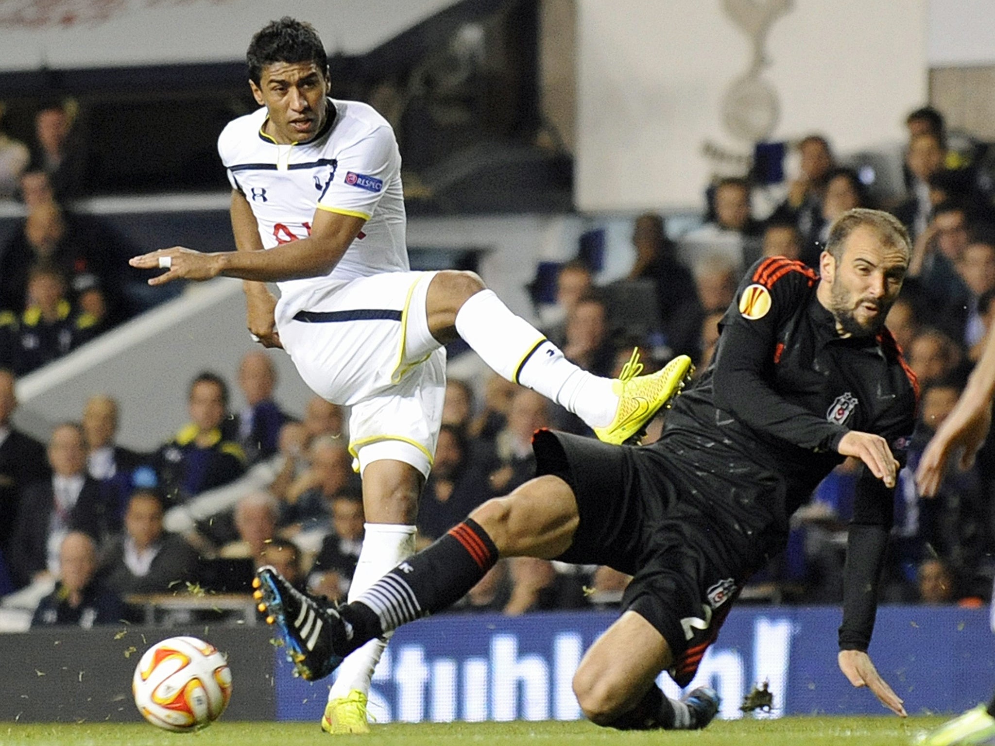 Tottenham Hotspur's Paulinho (left) has his shot stopped by Besiktas JK's Serdar Kurtulus