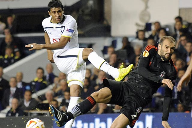 Tottenham Hotspur's Paulinho (left) has his shot stopped by Besiktas JK's Serdar Kurtulus