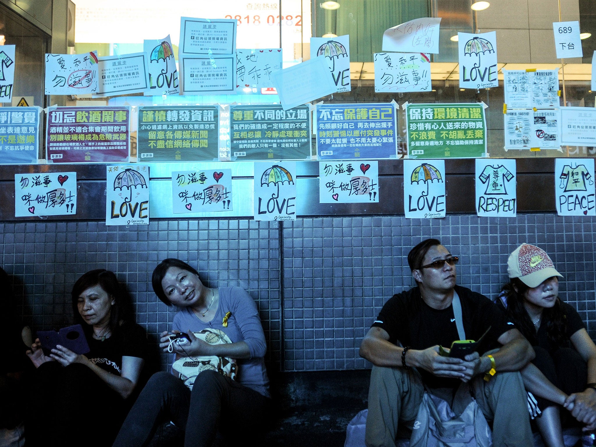 Pro-democracy demonstrators are seen near the Mong Kok MTR station in Hong Kong on 2 October