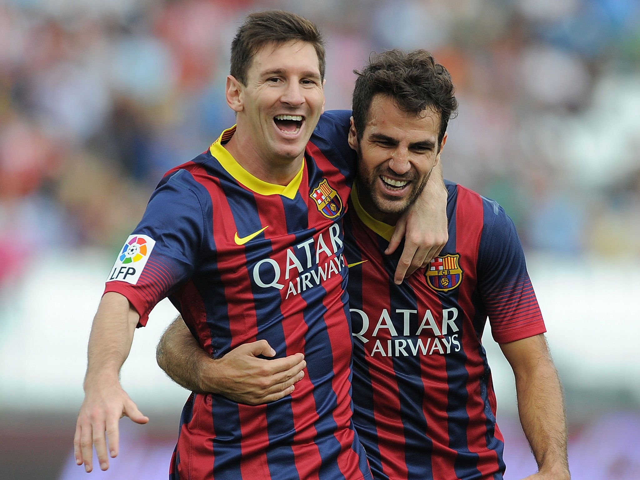Lionel Messi and Cesc Fabregas celebrate for Barcelona