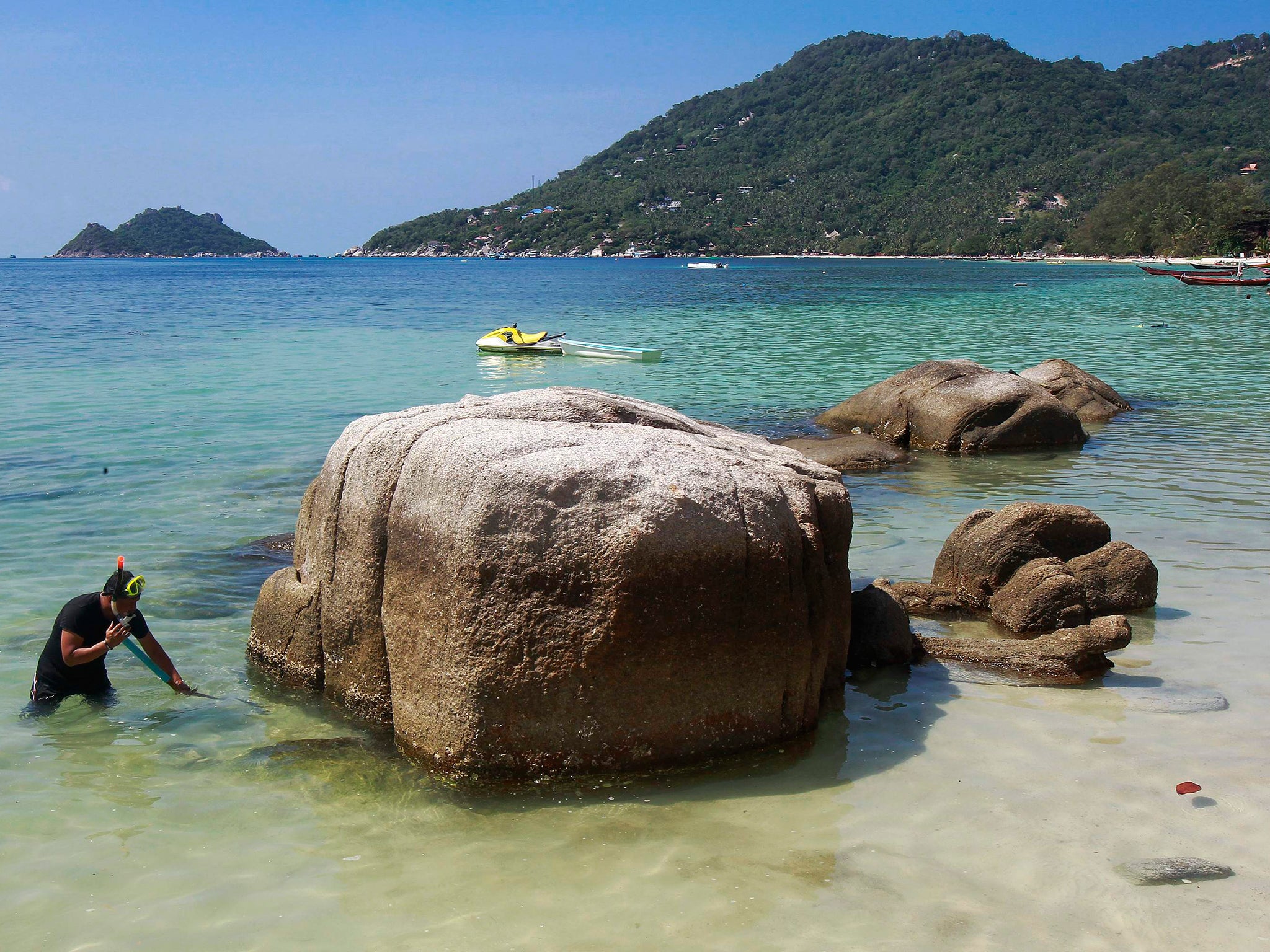 A police officer searches for clues near the spot where bodies of two killed British tourists were found, on the island of Koh Tao