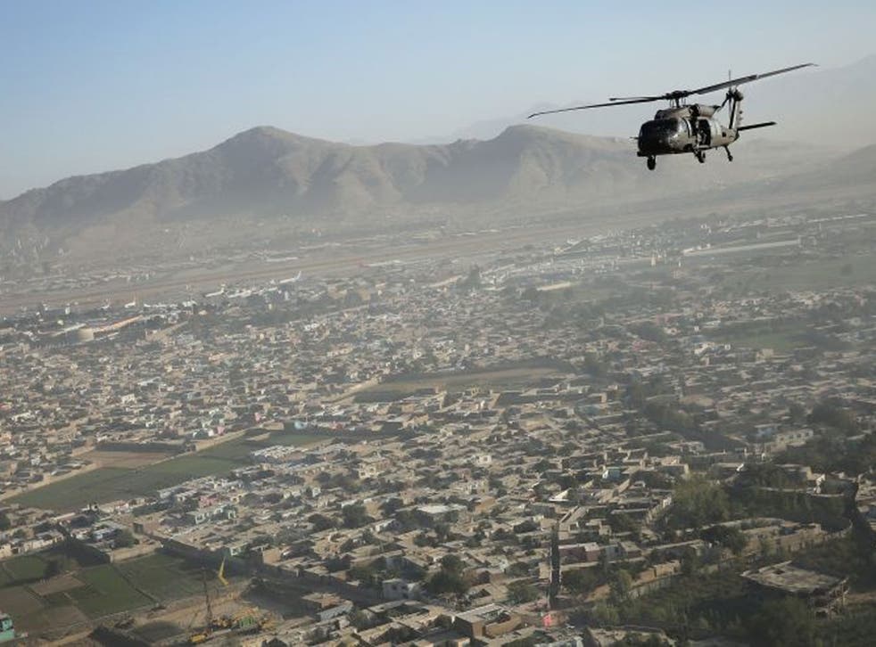 A Black Hawk flies over the city Kabul