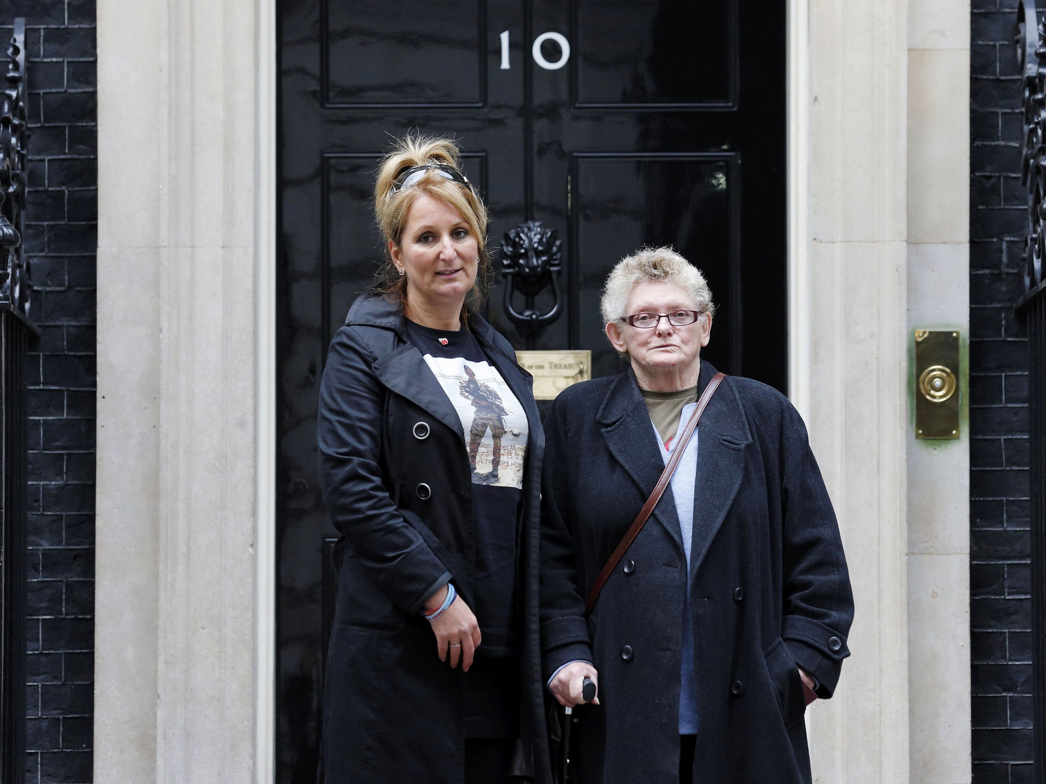 Caroline Munday (left), mother of British soldier James Munday, 21, who was killed in action in Afghanistan and Joan Humphreys (right) delivering a letter calling on David Cameron to bring troops home from Afghanistan. (Getty)