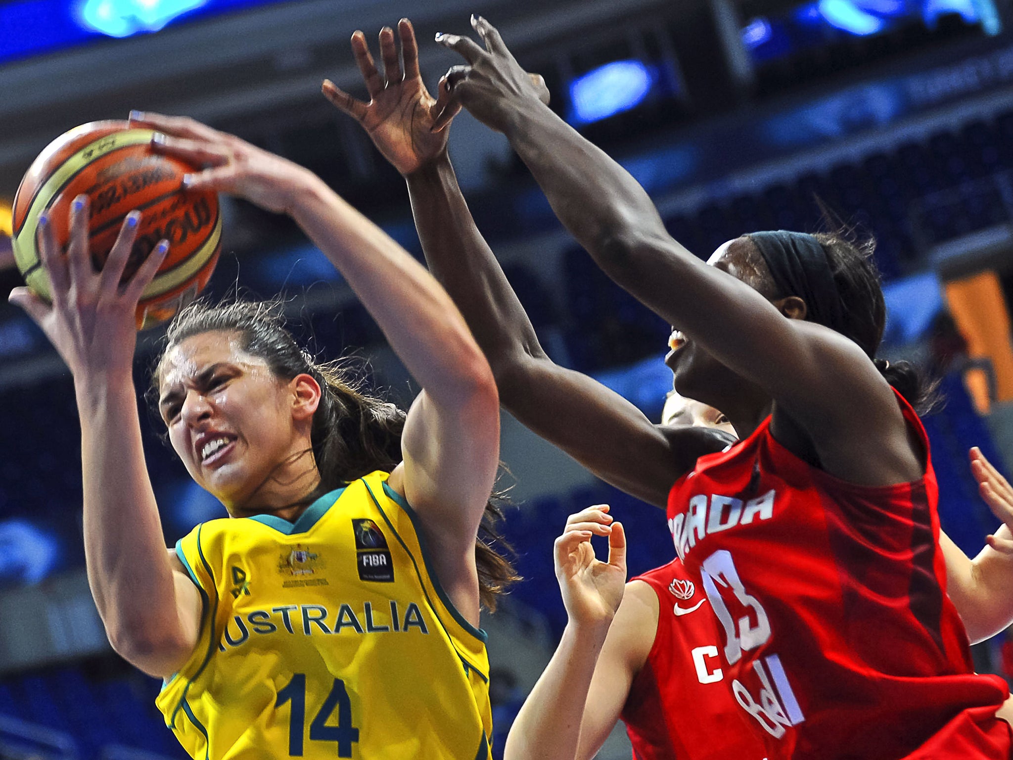 Australia's Marianna Tolo (L) vies for the ball with Canada's Tamara Tatham (R) during the 2014 FIBA Women's World Championships quarter-final basketball match between Australia and Canada at Fenerbahce Ulker Sports Arena in Istanbul